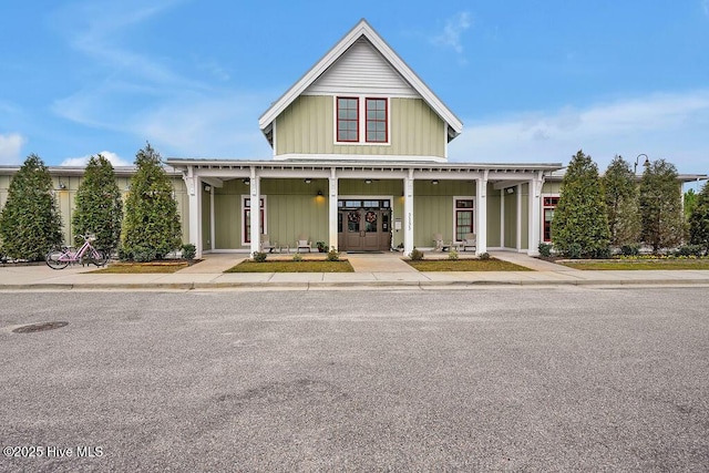 3350 Club Villas Dr # 105, Southport, NC 28461 - country-style home with board and batten siding and a porch