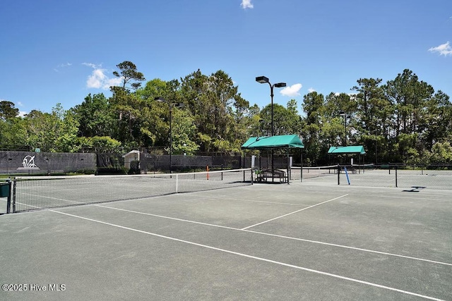 3350 Club Villas Dr # 105, Southport, NC 28461 - view of tennis court with view of scattered trees