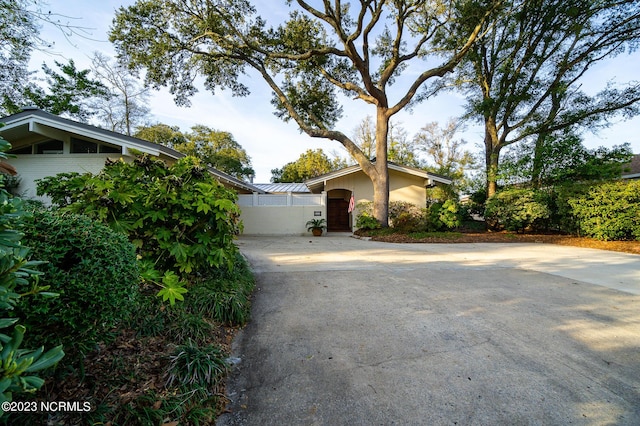 226 Oakleaf Dr, Pine Knoll Shores, NC 28512 - view of front of house with concrete driveway and a gate