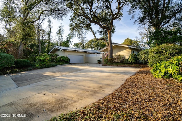 226 Oakleaf Dr, Pine Knoll Shores, NC 28512 - view of front of property with stucco siding, a garage, and concrete driveway