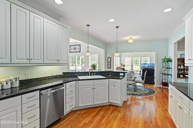 3254 Beaver Creek Dr SE, Southport, NC 28461 - kitchen with dishwasher, a sink, light wood-type flooring, a peninsula, and ornamental molding