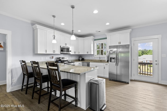 452 Crows Nest Ln, Sneads Ferry, NC 28460 - kitchen featuring appliances with stainless steel finishes, a peninsula, crown molding, white cabinetry, and recessed lighting