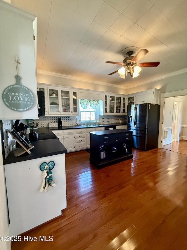 5934 NC-42, Macclesfield, NC 27852 - kitchen featuring stainless steel fridge with ice dispenser, crown molding, dark countertops, a sink, and a kitchen island