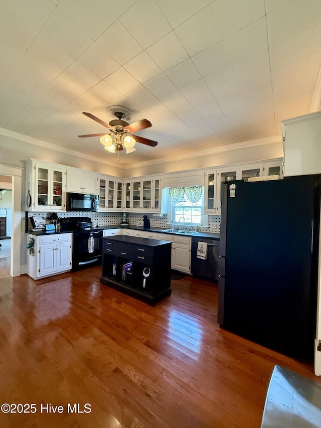 5934 NC-42, Macclesfield, NC 27852 - kitchen featuring black appliances, crown molding, a kitchen island, white cabinetry, and backsplash