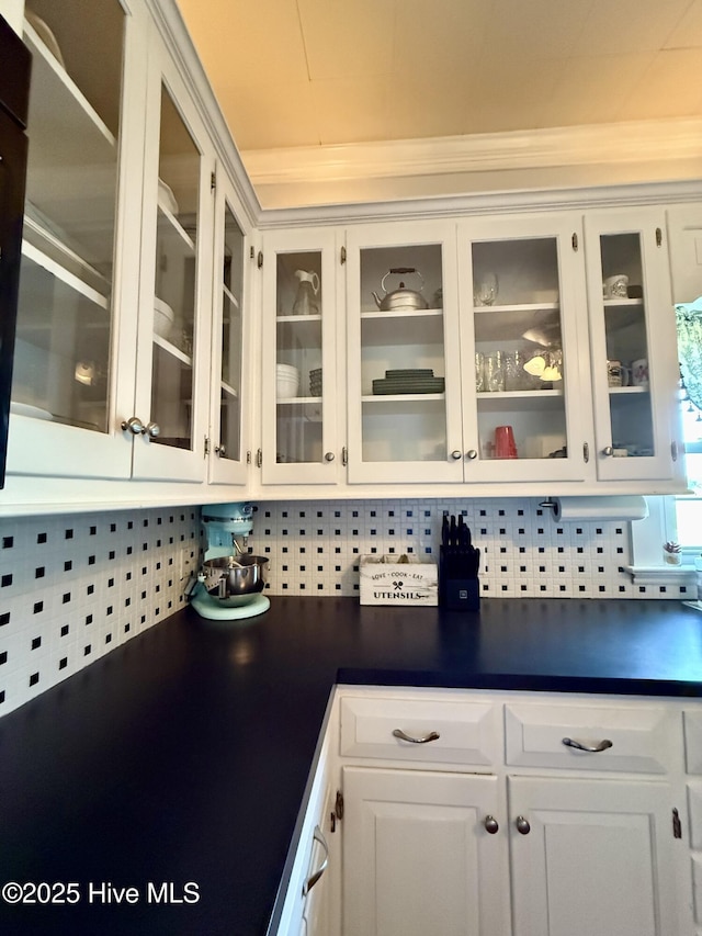 5934 NC-42, Macclesfield, NC 27852 - kitchen with dark countertops, white cabinetry, glass insert cabinets, and ornamental molding