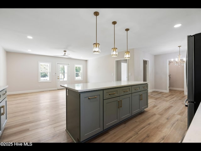 109 Inlet Ct, Hampstead, NC 28443 - kitchen featuring freestanding refrigerator, light countertops, light wood finished floors, gray cabinets, and recessed lighting