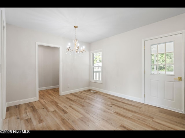 109 Inlet Ct, Hampstead, NC 28443 - unfurnished dining area featuring healthy amount of natural light, a chandelier, and light wood-style flooring