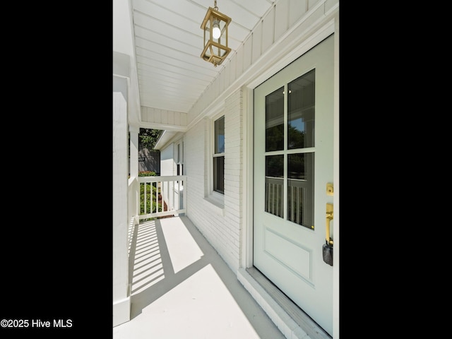 109 Inlet Ct, Hampstead, NC 28443 - view of exterior entry with covered porch and board and batten siding