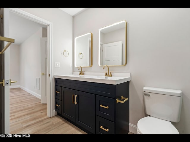 109 Inlet Ct, Hampstead, NC 28443 - bathroom with wood finished floors, double vanity, toilet, and baseboards