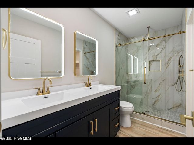 109 Inlet Ct, Hampstead, NC 28443 - bathroom featuring toilet, a marble finish shower, wood finished floors, and double vanity