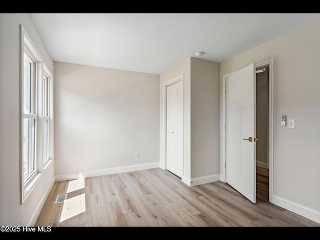 109 Inlet Ct, Hampstead, NC 28443 - unfurnished bedroom with light wood-style floors, baseboards, and a closet