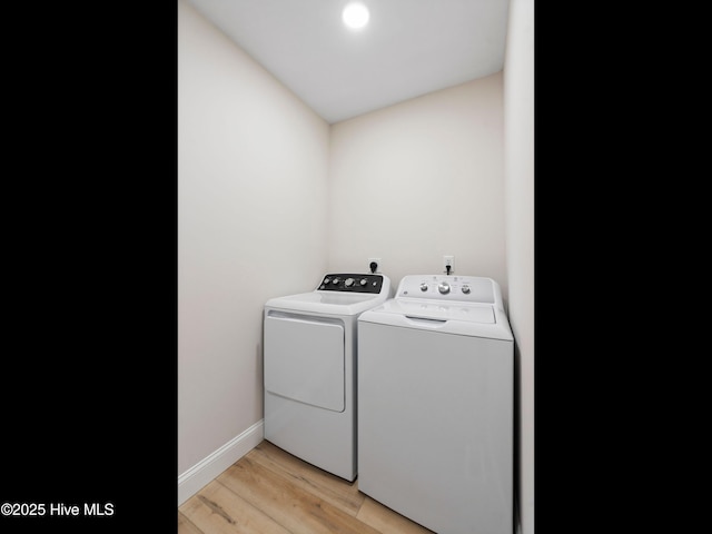 109 Inlet Ct, Hampstead, NC 28443 - laundry area featuring washing machine and clothes dryer, light wood-style flooring, and baseboards