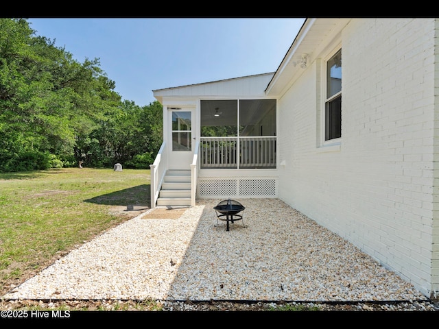 109 Inlet Ct, Hampstead, NC 28443 - view of exterior entry with a lawn and brick siding