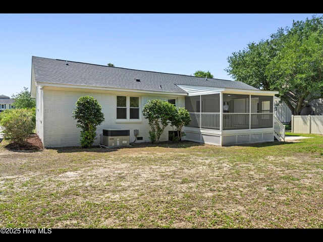 109 Inlet Ct, Hampstead, NC 28443 - rear view of property with a sunroom, central AC unit, brick siding, a yard, and roof with shingles