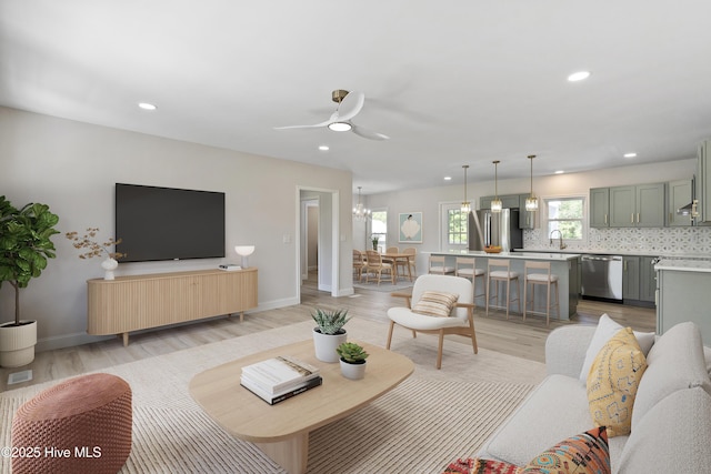 109 Inlet Ct, Hampstead, NC 28443 - living room with recessed lighting, light wood-type flooring, ceiling fan, baseboards, and a chandelier