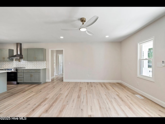 109 Inlet Ct, Hampstead, NC 28443 - kitchen with wall chimney exhaust hood, stainless steel range, gray cabinets, light wood-style flooring, and recessed lighting