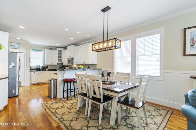 209 Georgia Ave, Carolina Beach, NC 28428 - dining room with ornamental molding, a wainscoted wall, light wood finished floors, recessed lighting, and a chandelier