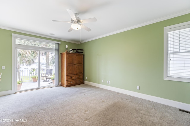 209 Georgia Ave, Carolina Beach, NC 28428 - empty room with light colored carpet, crown molding, plenty of natural light, a ceiling fan, and baseboards