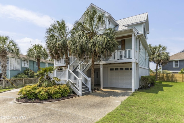 209 Georgia Ave, Carolina Beach, NC 28428 - coastal home with a garage, driveway, a porch, metal roof, and stairway