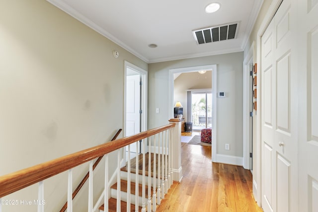 209 Georgia Ave, Carolina Beach, NC 28428 - corridor with an upstairs landing, light wood finished floors, baseboards, and crown molding