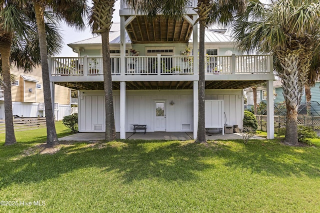 209 Georgia Ave, Carolina Beach, NC 28428 - rear view of house with board and batten siding and a patio area