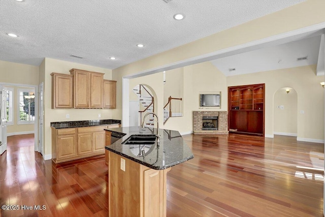 205 S Grist Mill Rd, Hampstead, NC 28443 - kitchen featuring a sink, baseboards, a brick fireplace, wood finished floors, and open floor plan