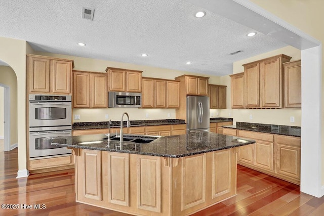 205 S Grist Mill Rd, Hampstead, NC 28443 - kitchen with appliances with stainless steel finishes, a sink, wood finished floors, a large island, and a textured ceiling