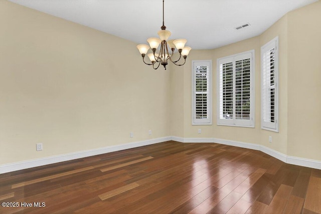 205 S Grist Mill Rd, Hampstead, NC 28443 - empty room with a chandelier, baseboards, and dark wood finished floors