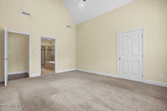 205 S Grist Mill Rd, Hampstead, NC 28443 - unfurnished bedroom featuring high vaulted ceiling, baseboards, carpet floors, and ensuite bath