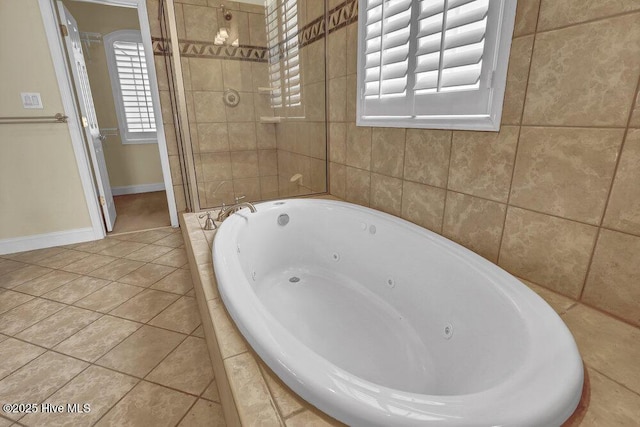 205 S Grist Mill Rd, Hampstead, NC 28443 - bathroom with a jetted tub, tile patterned flooring, tiled shower, and baseboards