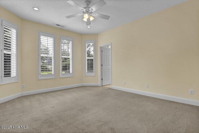 205 S Grist Mill Rd, Hampstead, NC 28443 - empty room with light carpet, baseboards, ceiling fan, a textured ceiling, and recessed lighting