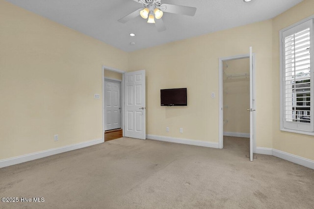 205 S Grist Mill Rd, Hampstead, NC 28443 - unfurnished bedroom with carpet floors, baseboards, a walk in closet, ceiling fan, and a closet