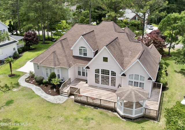 205 S Grist Mill Rd, Hampstead, NC 28443 - rear view of house featuring a shingled roof, a lawn, and a deck