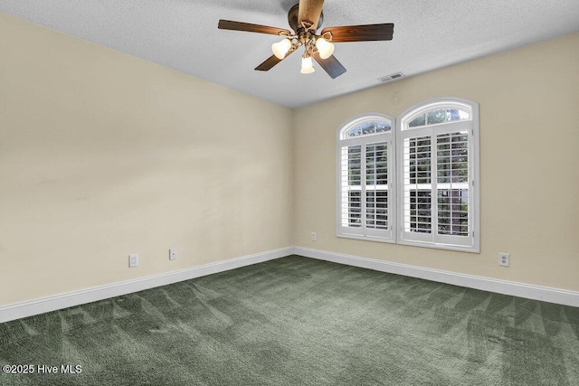 205 S Grist Mill Rd, Hampstead, NC 28443 - spare room featuring dark carpet, baseboards, ceiling fan, and a textured ceiling
