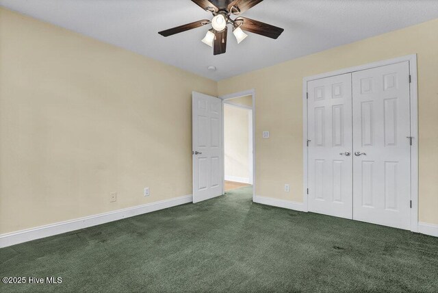 205 S Grist Mill Rd, Hampstead, NC 28443 - unfurnished bedroom featuring dark colored carpet, baseboards, a closet, and a ceiling fan