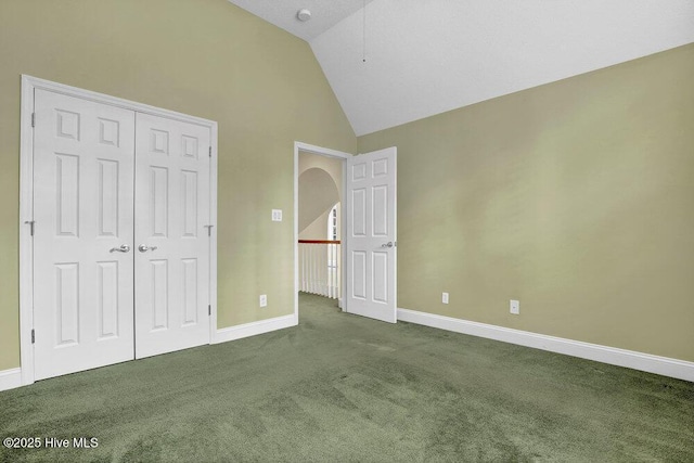 205 S Grist Mill Rd, Hampstead, NC 28443 - unfurnished bedroom featuring carpet floors, baseboards, a closet, and high vaulted ceiling
