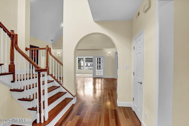 205 S Grist Mill Rd, Hampstead, NC 28443 - hallway featuring arched walkways, wood finished floors, stairs, and baseboards