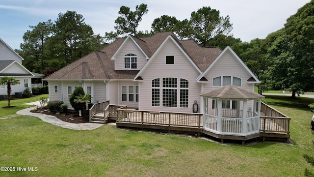 205 S Grist Mill Rd, Hampstead, NC 28443 - rear view of house with a shingled roof, a lawn, and a wooden deck