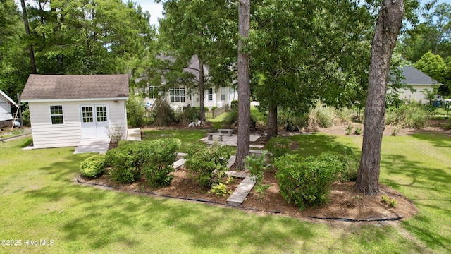 205 S Grist Mill Rd, Hampstead, NC 28443 - view of green lawn with an outdoor structure and view of scattered trees