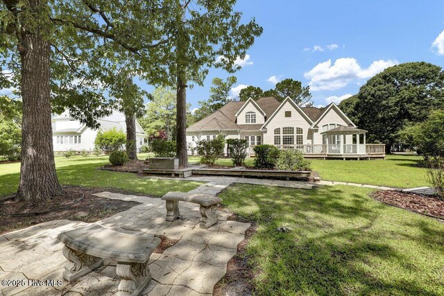 205 S Grist Mill Rd, Hampstead, NC 28443 - view of grassy yard featuring a deck and a patio