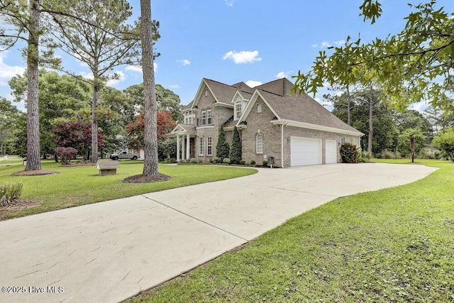 205 S Grist Mill Rd, Hampstead, NC 28443 - traditional-style home with a garage, a front lawn, and driveway
