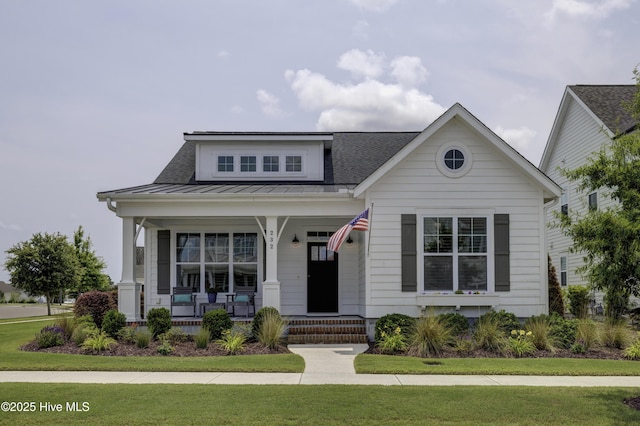 232 Trawlers Way, Wilmington, NC 28412 - view of front facade featuring covered porch, a standing seam roof, a front lawn, and metal roof