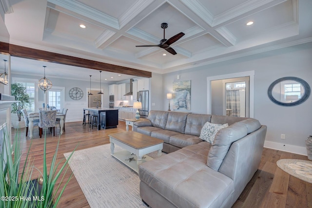 232 Trawlers Way, Wilmington, NC 28412 - living area featuring beamed ceiling, a ceiling fan, baseboards, light wood-type flooring, and a chandelier