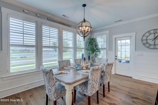 232 Trawlers Way, Wilmington, NC 28412 - dining area featuring a chandelier, wood finished floors, crown molding, and wainscoting