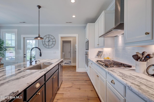232 Trawlers Way, Wilmington, NC 28412 - kitchen featuring wall chimney exhaust hood, a sink, appliances with stainless steel finishes, white cabinetry, and tasteful backsplash