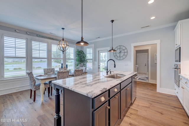 232 Trawlers Way, Wilmington, NC 28412 - kitchen featuring a sink, stainless steel appliances, white cabinets, light wood-style flooring, and crown molding