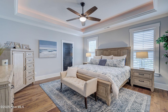 232 Trawlers Way, Wilmington, NC 28412 - bedroom featuring a tray ceiling, wood finished floors, baseboards, ornamental molding, and ceiling fan