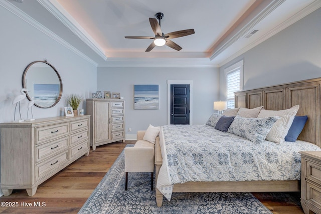 232 Trawlers Way, Wilmington, NC 28412 - bedroom with a tray ceiling, wood finished floors, ornamental molding, and ceiling fan