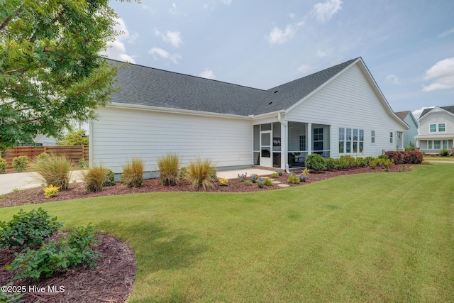 232 Trawlers Way, Wilmington, NC 28412 - back of house featuring a sunroom, roof with shingles, and a patio area