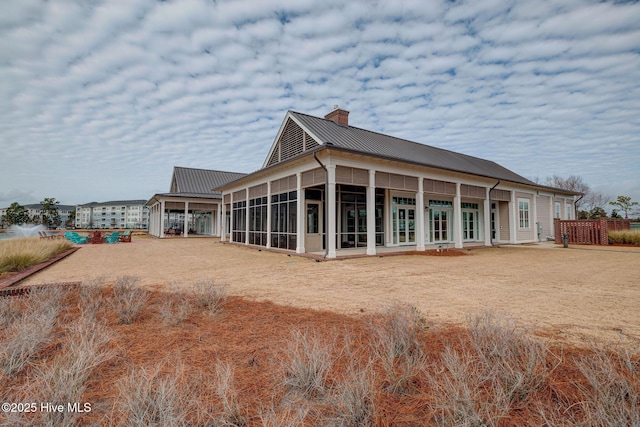 232 Trawlers Way, Wilmington, NC 28412 - rear view of house with a chimney, a sunroom, and metal roof